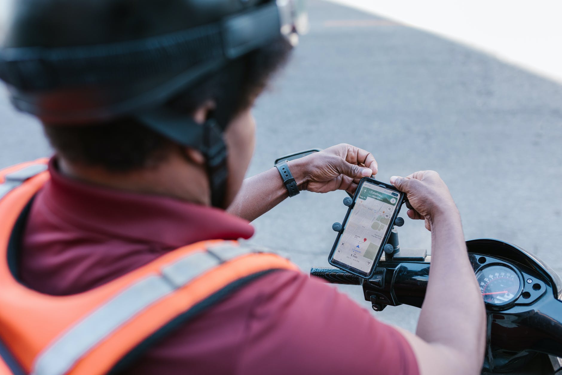 man in red shirt holding black dslr camera