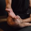 man practicing meditation on sports mat